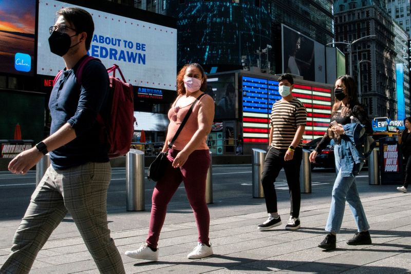 FILE PHOTO: People wear masks around Times Square, as cases of the infectious coronavirus Delta variant continue to rise in New York City, New York