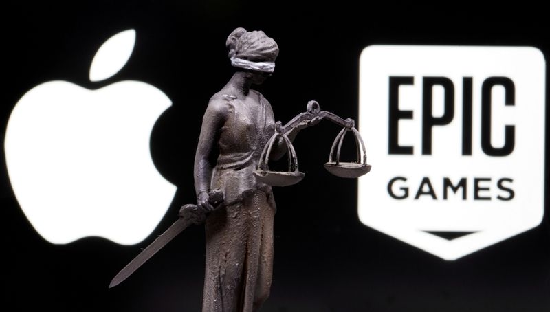 FILE PHOTO: 3D printed Lady Justice figure is seen in front of displayed Apple and Epic Games logos in this illustration photo