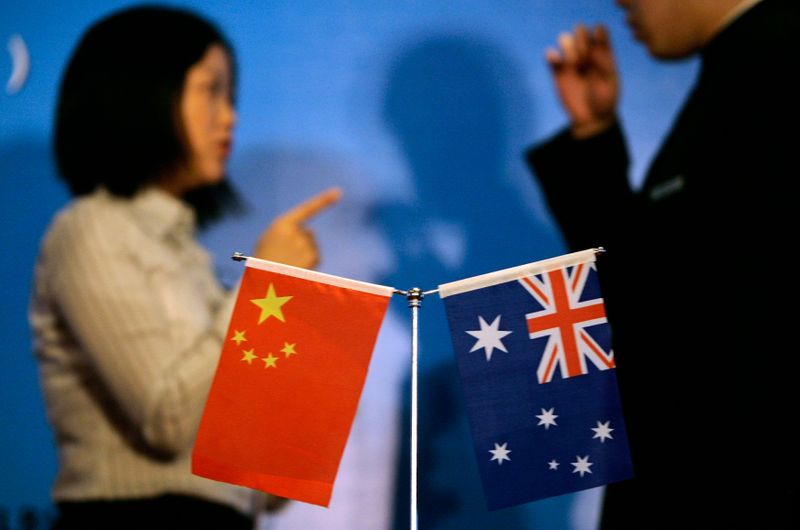 FILE PHOTO: Staff members chat as they prepare a seminar in Beijing