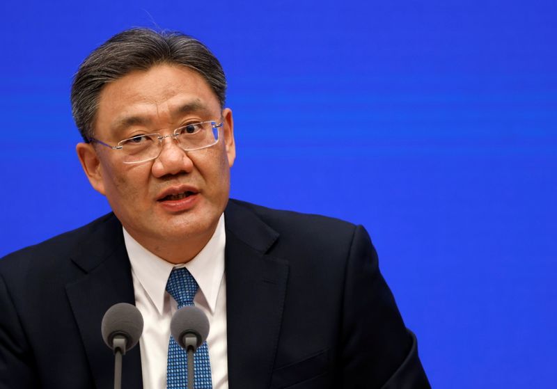 Chinese Commerce Minister Wang Wentao attends a State Council Information Office news conference in Beijing