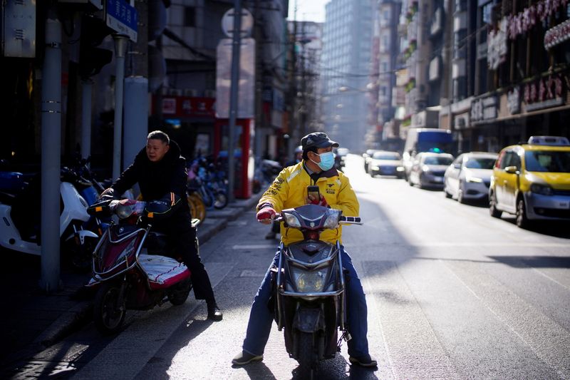 FILE PHOTO: A Meituan delivery worker wearing a face mask is seen on a street following an outbreak of the coronavirus disease (COVID-19) in Shanghai