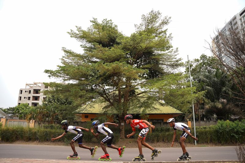 Serge Makolo leads his speed skating teammates during training in Kinshasa