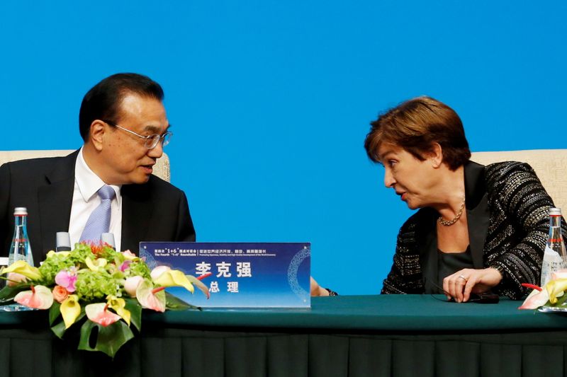 FILE PHOTO: IMF Managing Director Kristalina Georgieva talks to Chinese Premier Li Keqiang before a news conference following the 