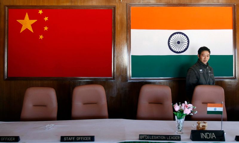 A man walks inside a conference room used for meetings between military commanders of China and India, at the Indian side of the Indo-China border at Bumla