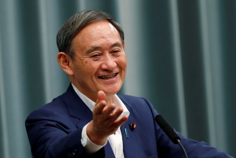 FILE PHOTO: Japan's Chief Cabinet Secretary Suga holds a regular news conference in Tokyo