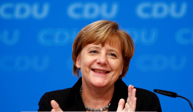 FILE PHOTO: German Chancellor and leader of the CDU Merkel applauds after the overwhelming vote on a declaration about refugees during the CDU party congress in Karlsruhe