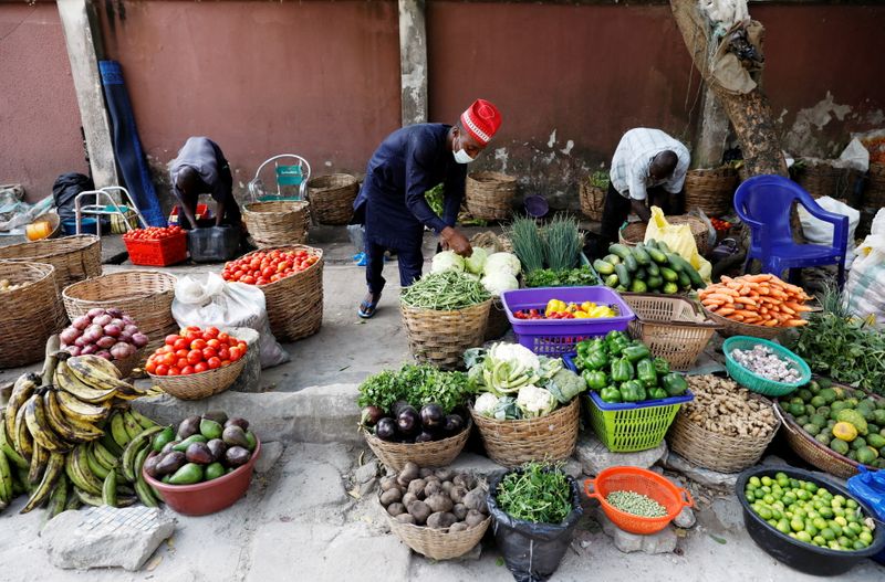 FILE PHOTO: Vendors sell vegetables at a street market in Victoria Island, in Lagos