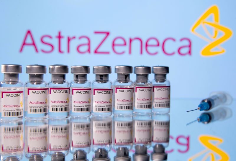 FILE PHOTO: Vials labelled 'Astra Zeneca COVID-19 Coronavirus Vaccine' and a syringe are seen in front of a displayed AstraZeneca logo in this illustration photo