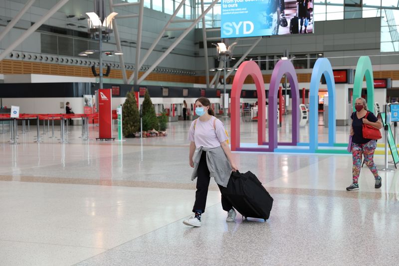 FILE PHOTO: People walk through the domestic terminal at Sydney Airport in Sydney, Australia