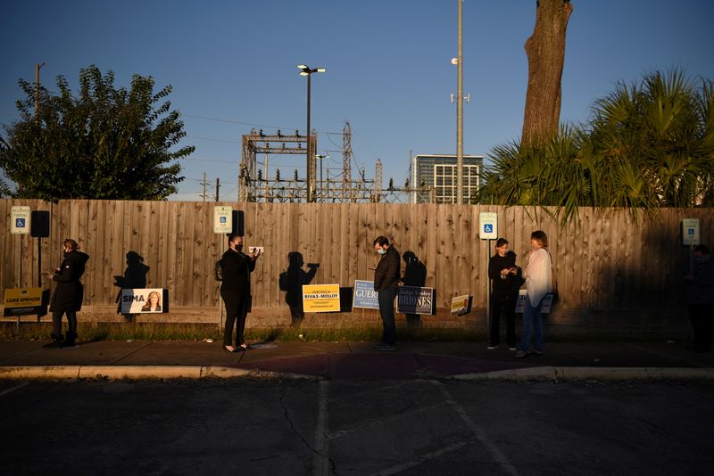 Voters line up at a polling station during Election Day in Houston