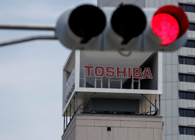 FILE PHOTO: The logo of Toshiba Corp. is seen next to a traffic signal atop of a building in Tokyo