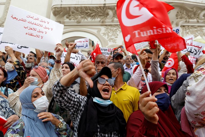 Opponents of Tunisia's President Kais Saied protest against what they call his coup on July 25, in Tunis