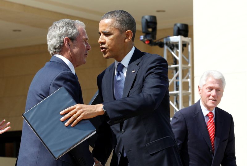 FILE PHOTO: U.S. President Barack Obama embraces George W. Bush following remarks at the dedication ceremony of the George W. Bush Presidential Center in Dallas