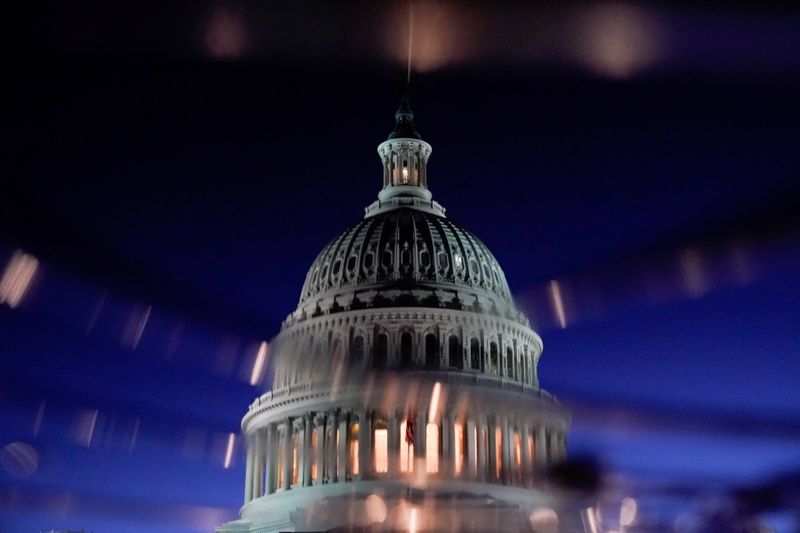 FILE PHOTO: The U.S. Capitol dome is seen reflected in a puddle in Washington