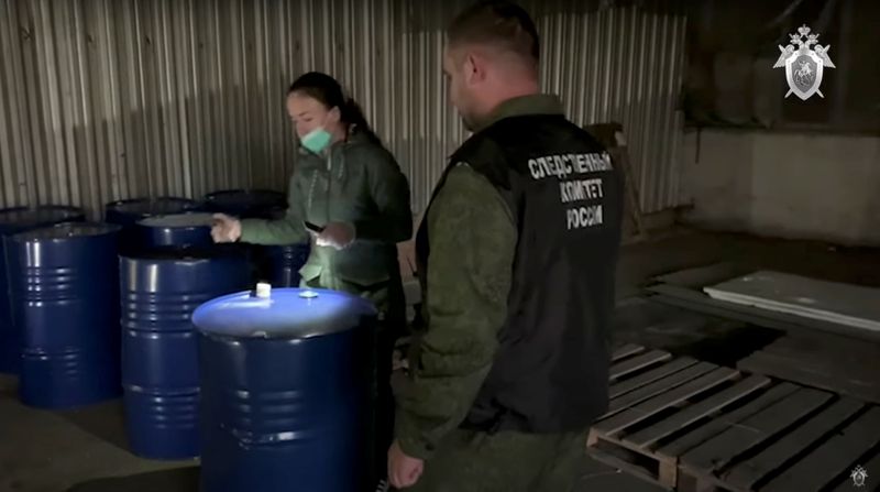 Members of the Russian Investigative Committee investigate a criminal case of deaths of people from alcohol poisoning in Orenburg Region