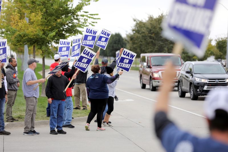 Striking members of the United Auto Workers (UAW) picket at the Deere & Co farm equipment plant before a visit by U.S. Agriculture Secretary Tom Vilsack in Ankeny, Iowa