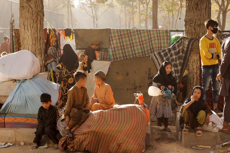 Displaced Afghan families, who flee the violence in their provinces, stay in a makeshift shelter, in Kabul