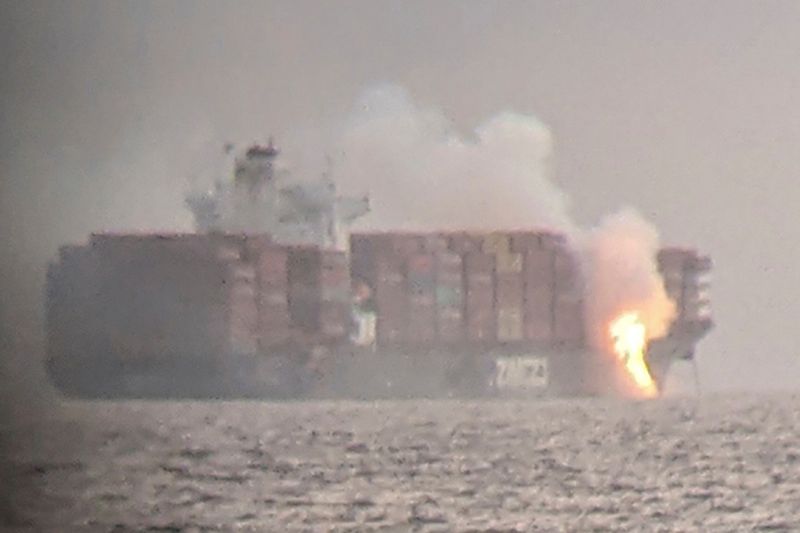 Fire cascades down from the deck of the container ship ZIM Kingston into the waters off the coast of Victoria, British Columbia, Canada