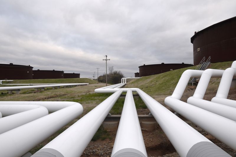 FILE PHOTO: Pipelines run to Enbridge Inc.'s crude oil storage tanks at their tank farm in Cushing
