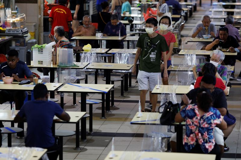 People eat at a hawker centre during the coronavirus disease (COVID-19) outbreak, in Singapore