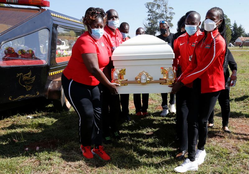 Kenyan athletes carry the coffin of long-distance runner Agnes Tirop before her funeral service at Kapnyamisa village