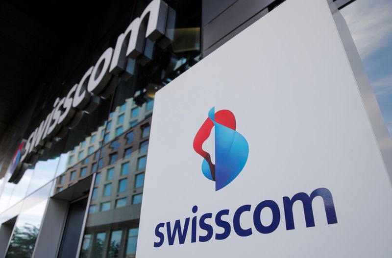 FILE PHOTO: The logo of Swiss telecoms group Swisscom is seen at an office building, in Zurich