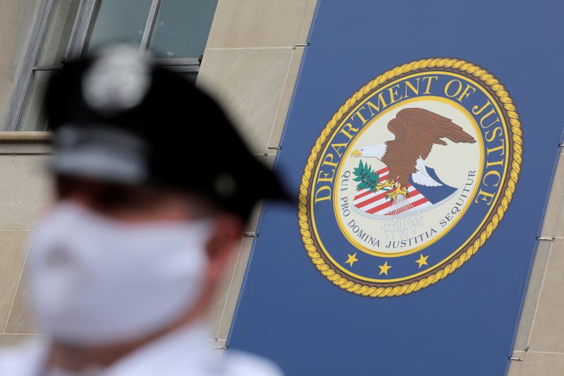 Security stands guard at the headquarters of the United States Department of Justice (DOJ) in Washington, D.C.