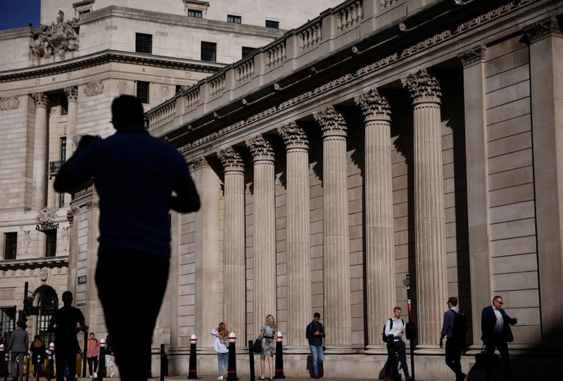 FILE PHOTO: People walk past the Bank of England during morning rush hour, amid the coronavirus disease