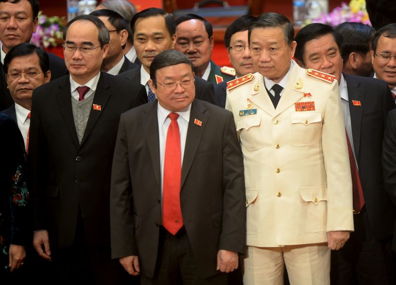 FILE PHOTO: Newly elected Politburo member To Lam, in white uniform, poses in Hanoi
