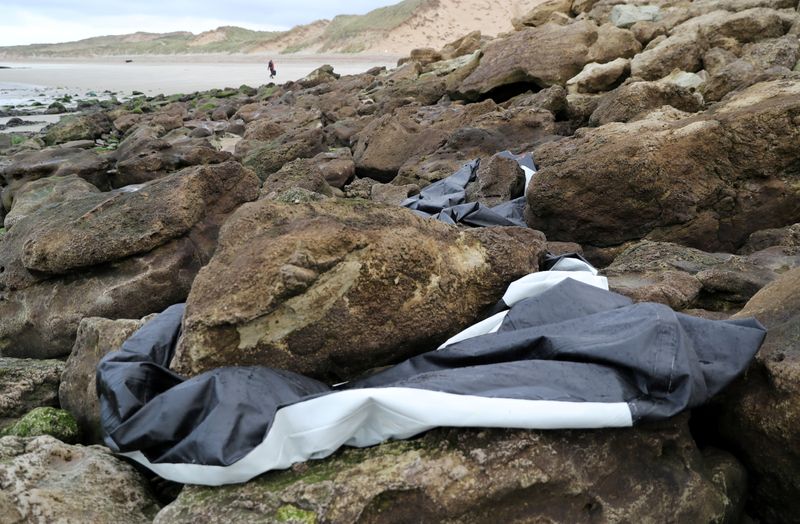 A damaged inflatable dinghy is seen near the Slack dunes in Wimereux after migrant tragedy