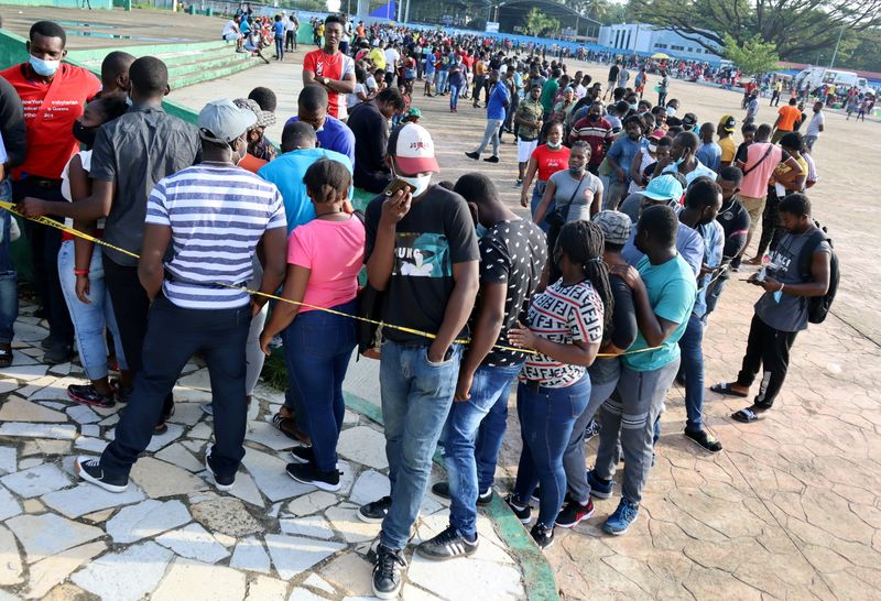 FILE PHOTO: Migrants wait in line for asylum processing by Mexico's COMAR in Tapachula