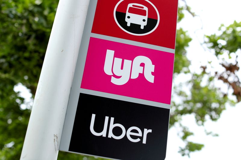 FILE PHOTO: The logos of Lyft and Uber are displayed in San Diego