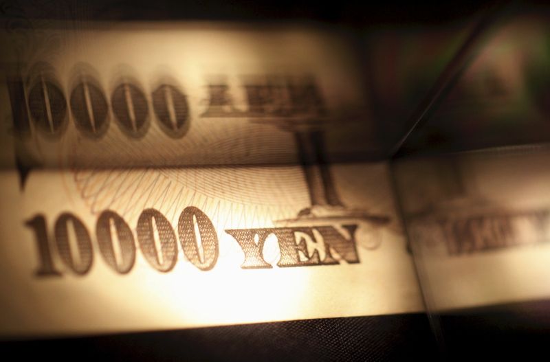 FILE PHOTO: Light is cast on a Japanese 10,000 yen note as it's reflected in a plastic board in Tokyo, in this picture illustration