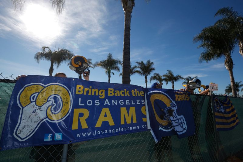 NFL fans show their support for the St. Louis Rams NFL team to come to Los Angeles at a news conference to unveil plans for development at the site of the former Hollywood Park Race Track in Inglewood, Los Angeles