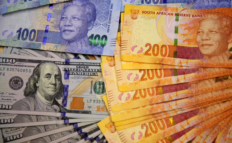 FILE PHOTO: Photo illustration of South African bank notes displayed next to the American dollar notes in Johannesburg