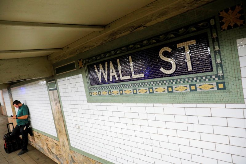 FILE PHOTO: A person waits on the Wall Street subway platform in the Financial District of Manhattan, New York City
