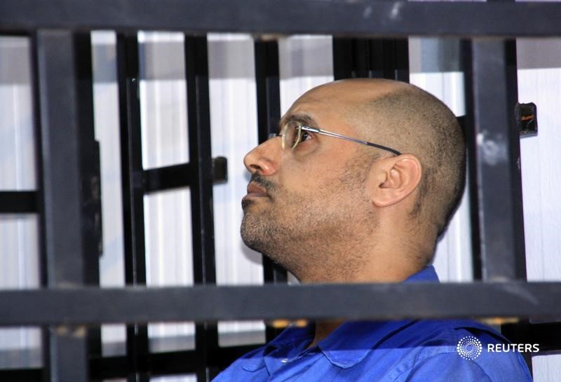 Saif al-Islam Gaddafi, son of late Libyan leader Muammar Gaddafi, attends a hearing behind bars in a courtroom in Zintan