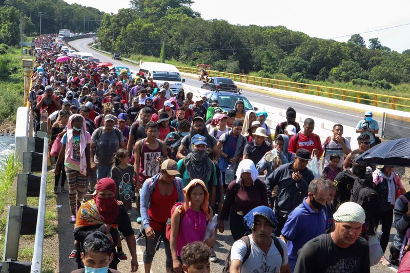 Migrants walk in a caravan headed to the Mexican capital to apply for asylum and refugee status