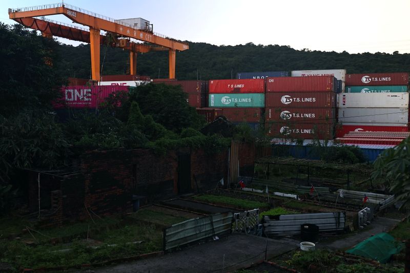 Cargo cranes are seen moving containers at a container yard in Keelung