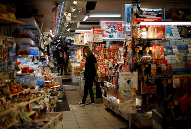Shoppers wearing protective face masks, amid the coronavirus disease (COVID-19) pandemic, are seen inside a souvenir shop in Okinawa