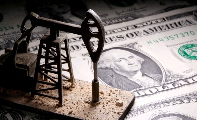 FILE PHOTO: FILE PHOTO: A 3D printed oil pump jack is placed on dollar banknotes in this illustration picture