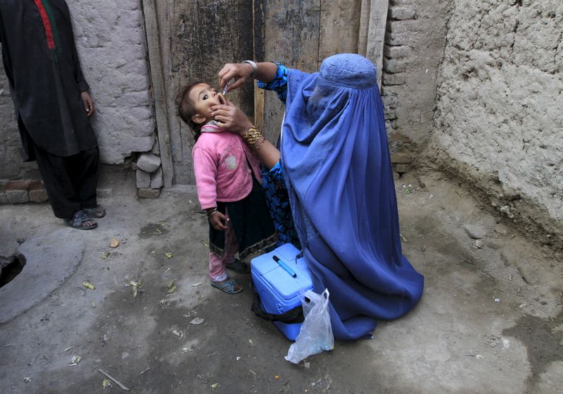 A child receives a polio vaccination during an anti-polio campaign on the outskirts of Jalalabad, Afghanistan