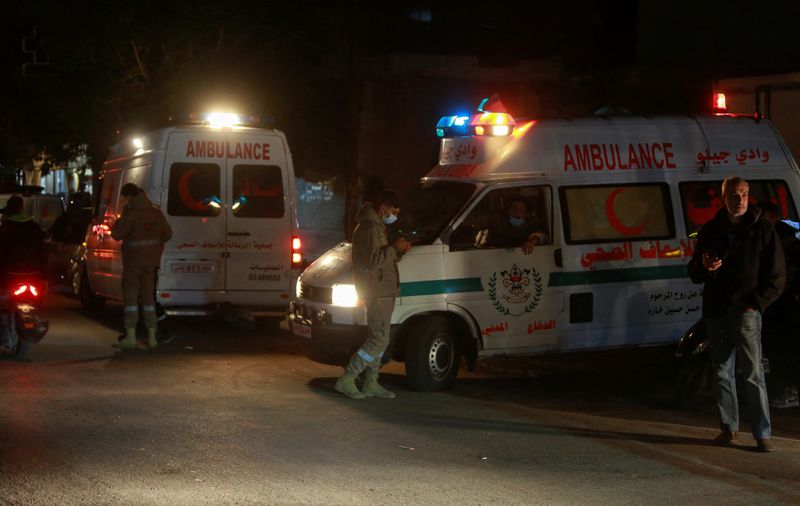 Ambulances are parked at the entrance of the Palestinian camp where an explosion took place in Tyre