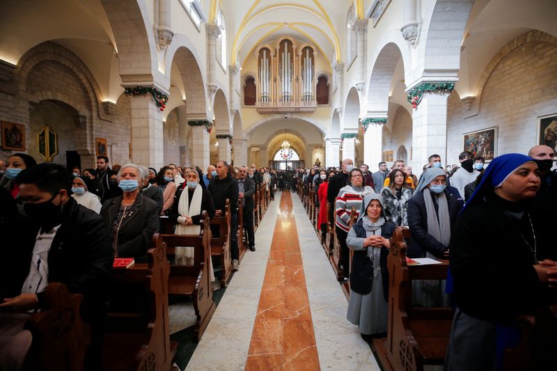 Worshippers attend Christmas morning mass as COVID-19 subdues festivities in Bethlehem