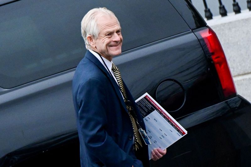 FILE PHOTO: White House advisor Peter Navarro leaves the West Wing carrying a poster board displaying claims of voting irregularity at the White House in Washington