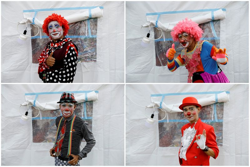 Clowns perform for the people who were affected by the eruption of Mount Semeru volcano, inside a temporary tent in Penanggal, Candipuro district, Lumajang