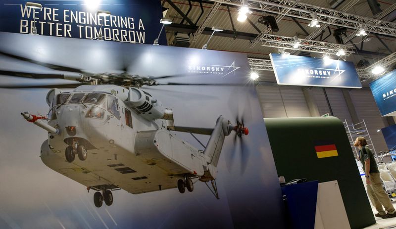 A photograph of a CH-53 helicopter is pictured at the booth of Sikorsky - Lockheed Martin company during preparation for the ILA Berlin Air Show in Schoenefeld