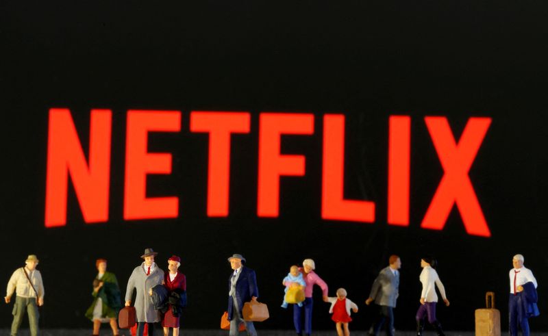 FILE PHOTO: Small toy figures are seen in front of diplayed Netflix logo