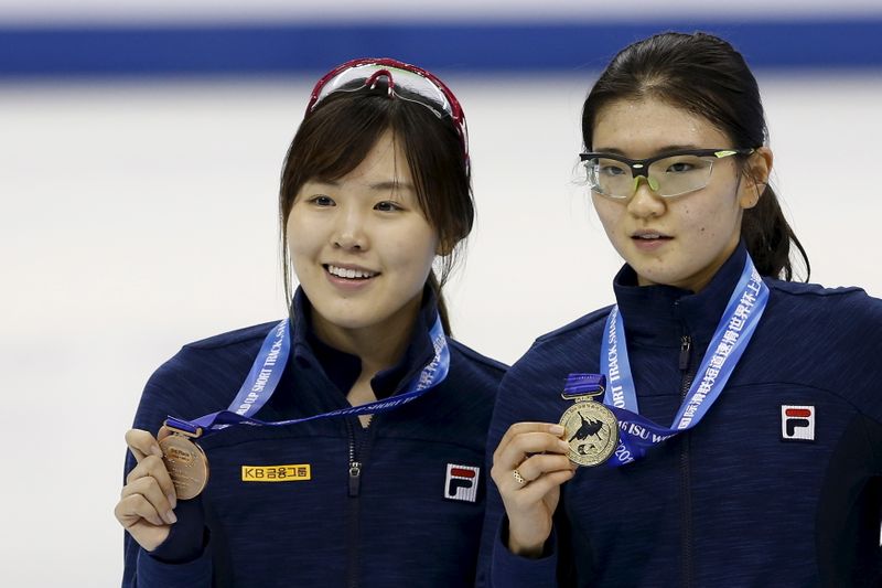 Gold medallist Shim of South Korea and her compatriot, bronze medallist Kim pose during the awards ceremony after the women's 1500m final during the ISU World Cup Short Track Speed Skating competition in Shanghai