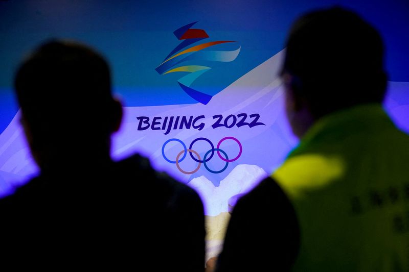 FILE PHOTO: Staff members work near the emblem for Beijing 2022 Winter Olympics displayed at the Shanghai Sports Museum in Shanghai